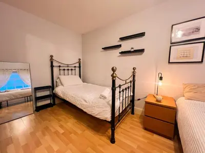 a bedroom with a twin bed and a night stand with a lamp at Cosy 2bed City Centre Flat! in Liverpool