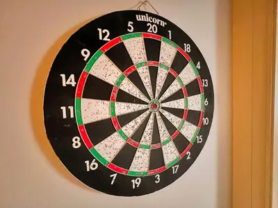 a dartboard hanging on a wall at Cosy 2bed City Centre Flat! in Liverpool