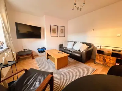 a living room with a couch and a table at Cosy 2bed City Centre Flat! in Liverpool