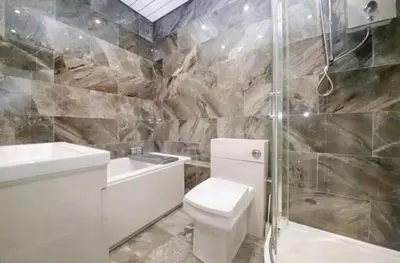 a bathroom with a toilet and a sink and a shower at 3 BR- Central Wigan- HOT TUB in Ince-in-Makerfield