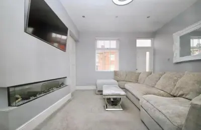 a living room with a couch and a flat screen tv at 3 BR- Central Wigan- HOT TUB in Ince-in-Makerfield