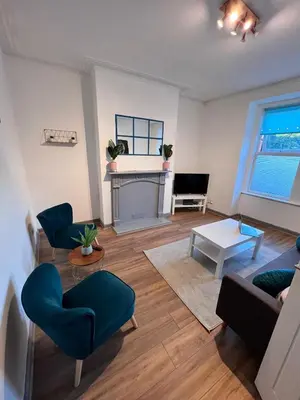 a living room with a couch and a fireplace at Stylish Retreat near Birkenhead & Liverpool Your Cozy Home Away From Home in Wallasey