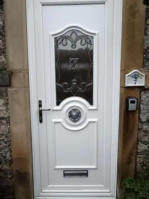 a white door with a window on it at Heatherlea in Grange Over Sands