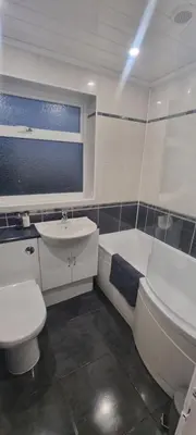 a bathroom with a toilet and a sink and a tub at 3 bed home in Bolton Le Sands in Bolton le Sands