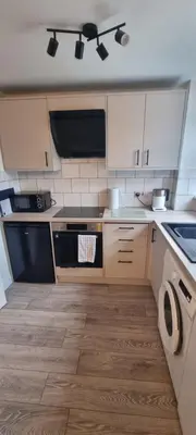 a kitchen with a sink and a stove top oven at 3 bed home in Bolton Le Sands in Bolton le Sands