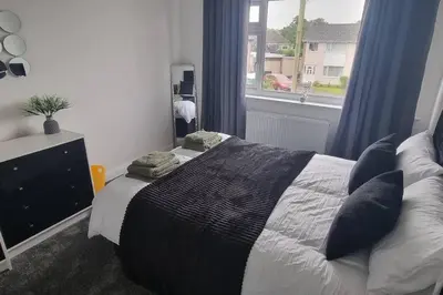 a bedroom with a bed with pillows and a window at 3 bed home in Bolton Le Sands in Bolton le Sands