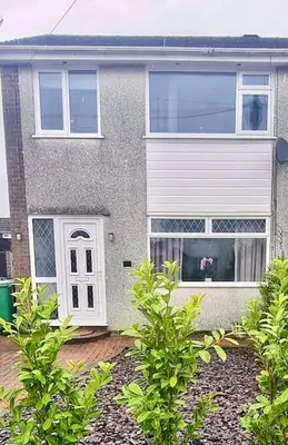 a house with a dog sitting in the window at 3 bed home in Bolton Le Sands in Bolton le Sands