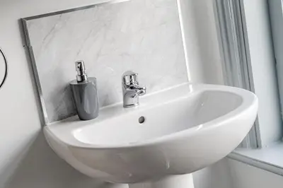 a white sink in a bathroom with a mirror at The Old Bike Shop Flat 2 in Heapey