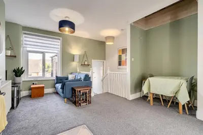 a living room with a couch and a table at The Old Bike Shop Flat 2 in Heapey
