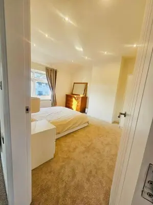 a white bedroom with a bed and a window at Luxe Residences - Preston in Preston