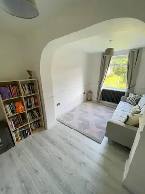 a living room with a couch and a book shelf at Luxe Residences - Preston in Preston