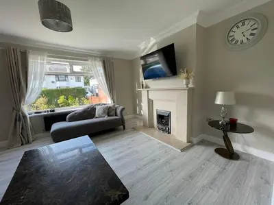 a living room with a couch and a fireplace at Luxe Residences - Preston in Preston