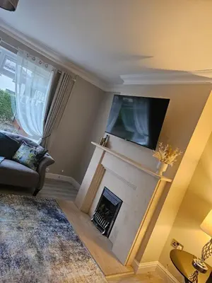 a living room with a fireplace and a tv at Luxe Residences - Preston in Preston