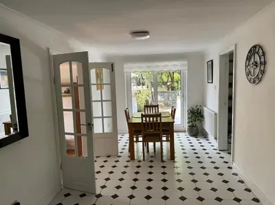 a dining room with a table and chairs at Sunshine cottage in Horwich