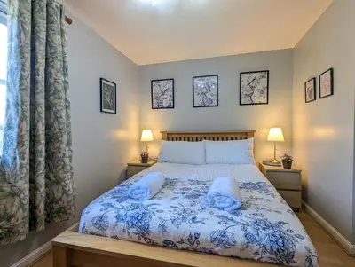 a bedroom with a bed with two pillows on it at City Centre Vintage Theme Guest Rooms in Liverpool