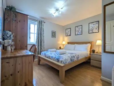 a bedroom with a bed and a desk and a window at City Centre Vintage Theme Guest Rooms in Liverpool