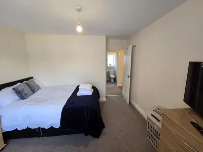 a bedroom with a bed and a flat screen tv at A Classic Home in Liverpool in Liverpool