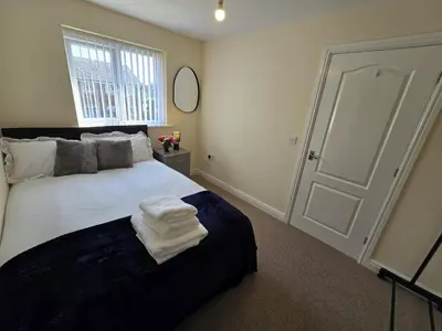 a bedroom with a white bed with towels on it at A Classic Home in Liverpool in Liverpool