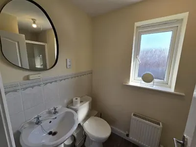 a bathroom with a sink and a toilet and a mirror at A Classic Home in Liverpool in Liverpool