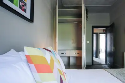 a bedroom with a bed with a mirror on the wall at Parkside View Wallasey 5 bedroom 5 bathroom with on-street parking ideal for Groups Families or Contractors with vans by Rework Accommodation in Wallasey