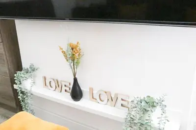 a black vase sitting on a shelf with a love sign at Anfield Walk in Liverpool