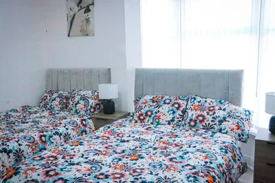 a bedroom with two beds with a floral comforter at Anfield Walk in Liverpool