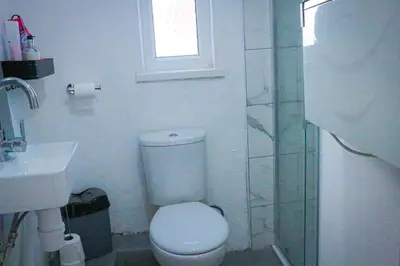 a bathroom with a toilet and a sink and a shower at Anfield Walk in Liverpool