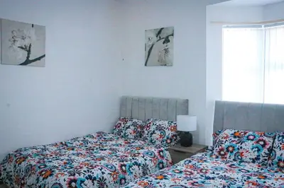 two beds sitting next to each other in a bedroom at Anfield Walk in Liverpool