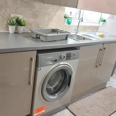 a kitchen with a washing machine and a sink at Accrington - House - Sleeps 10 - Garden in Accrington