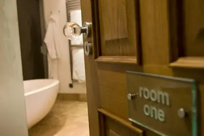 a bathroom with a door with a sign that says room one at The Rooms Lytham in Lytham St Annes