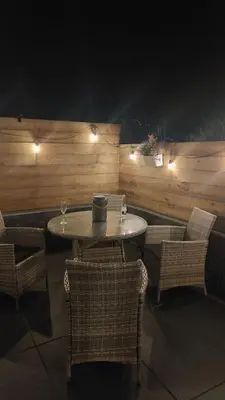 a restaurant with a table and chairs and lights at 2 Bed Cottage in Peaceful South Lakes Village in Cark