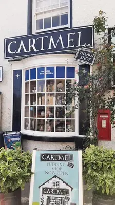 a store with a sign on the side of a building at 2 Bed Cottage in Peaceful South Lakes Village in Cark