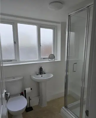 a bathroom with a toilet and a sink and a shower at Stylish City Centre Apartment with Parking in Preston