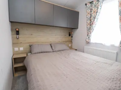 a bedroom with a large bed with a wooden headboard at Giorgio in Preston