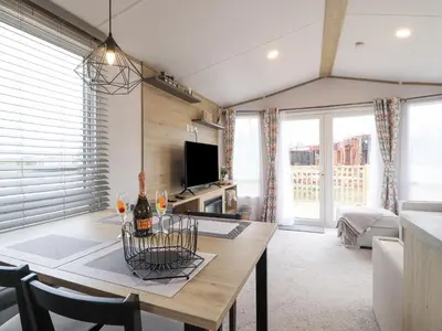 a living room with a table and a tv at Giorgio in Preston