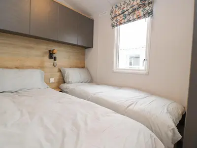 two beds in a room with a window at Giorgio in Preston