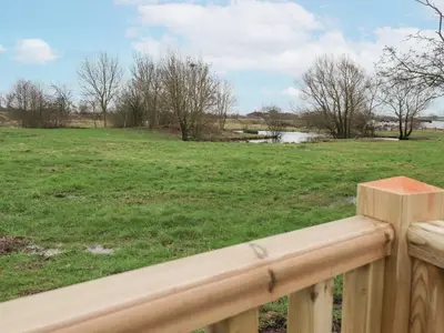 a wooden fence with a field in the background at Giorgio in Preston