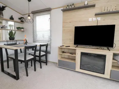 a living room with a table and a flat screen tv at Giorgio in Preston