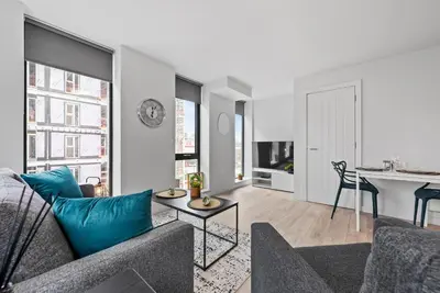 a living room with a couch and a table at Baltic Triangle Apartment in Liverpool