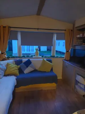 a bed in a room with a large window at Mags den in Morecambe