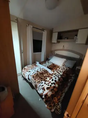a bedroom with a bed with a leopard print blanket at Mags den in Morecambe