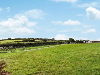 a grassy field with a fence in the distance at The Lodge Pod in Barrow in Furness
