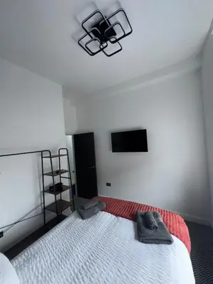 a bedroom with a bed and a tv on the wall at 38 Everton Road Free onsite parking in Liverpool