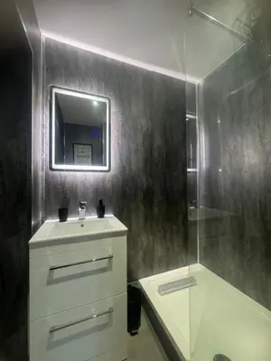 a bathroom with a shower and a sink and a mirror at 38 Everton Road Free onsite parking in Liverpool