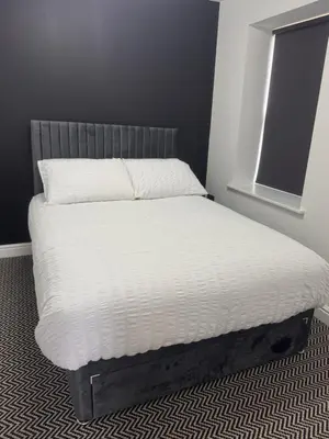 a bed in a bedroom with a white mattress at 38 Everton Road Free onsite parking in Liverpool