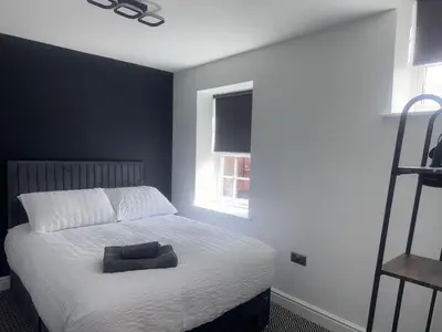a bedroom with a white bed and a window at 38 Everton Road Free onsite parking in Liverpool