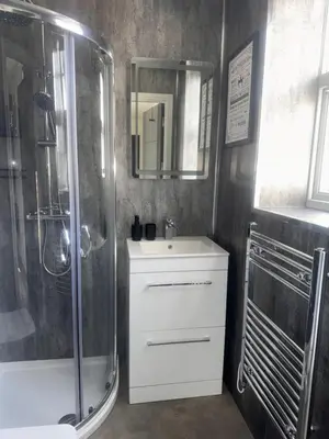 a bathroom with a shower and a sink and a mirror at 38 Everton Road Free onsite parking in Liverpool