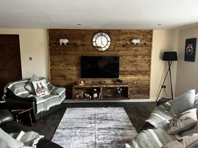 a living room with a couch and a flat screen tv at Luxury Country Lodge in Bretherton - Sleeps 4 in Bretherton