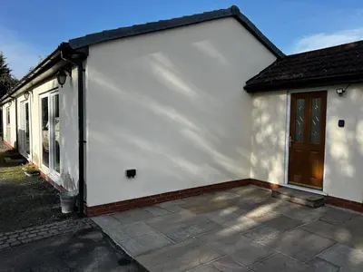 a white house with a door and a patio at Luxury Country Lodge in Bretherton - Sleeps 4 in Bretherton