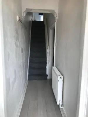 a hallway with a staircase and a stair case at Noble Prestige Place in Liverpool